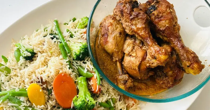chicken served with rice and vegetables as a side dish for crockpot chicken and gravy